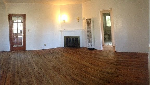 Gorgeous hardwood floors and fireplace in living room.
