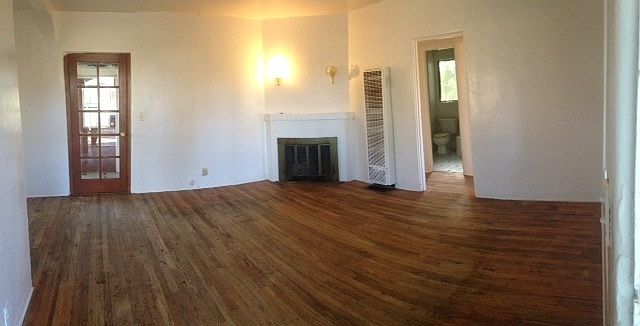 Gorgeous hardwood floors and fireplace in living room.