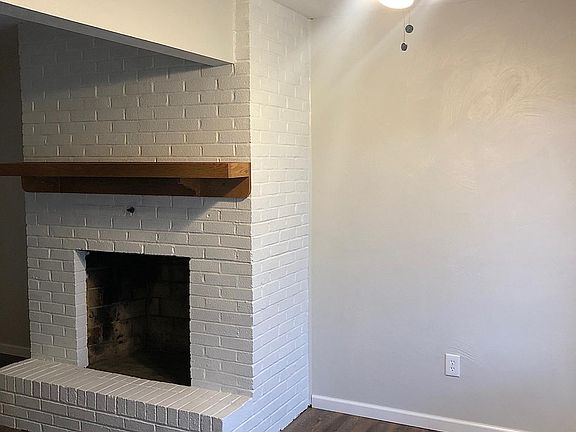 Living room/dining room with sliding patio door to private patio and green space.