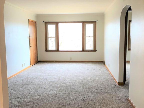 Large living room with crown moldings.