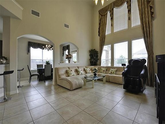 Open family and breakfast rooms, perfect for entertainment. Custom window treatments are yours!