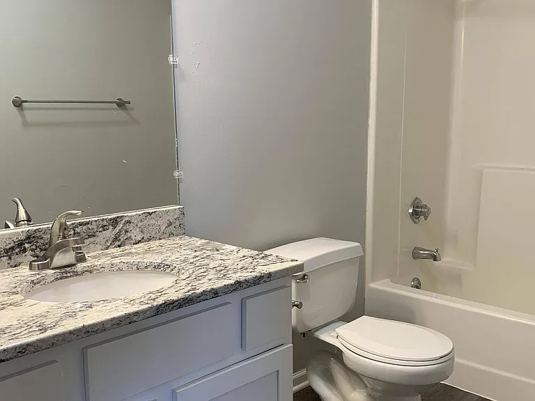 Step into a refreshed space with updated cabinetry, modern flooring, and a sleek granite-style countertop.