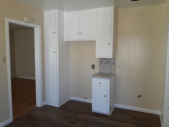 Large Country Kitchen with new quartz counter tops, new vinyl wood flooring. Opening for refrigerator, stove to right.