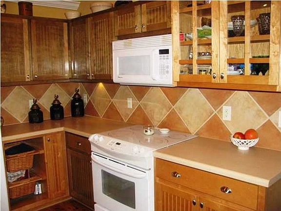 Unique Kitchen Design with Tile Back Spash and Custom Maple Cabinets