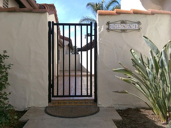Gated entry to access the front door and front patio/courtyard area.