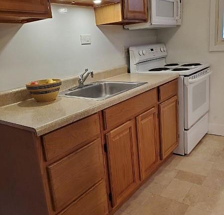 Kitchenette adjoins the large open living room.