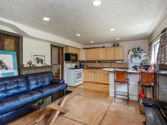 Living room, kitchen , dining bar, door to master bedroom