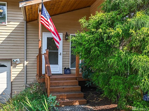 Main door entrance on a wooden deck stairs.