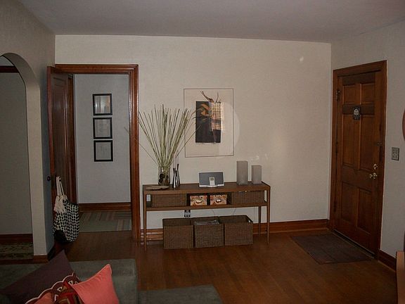View of the living room and entry way from the fireplace. 