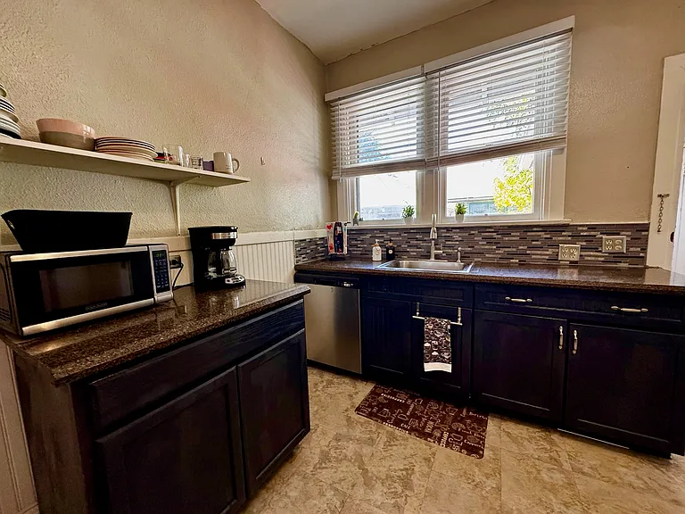 Kitchen. Coffee pot, microwave, oven with air fryer, and new dishwasher.