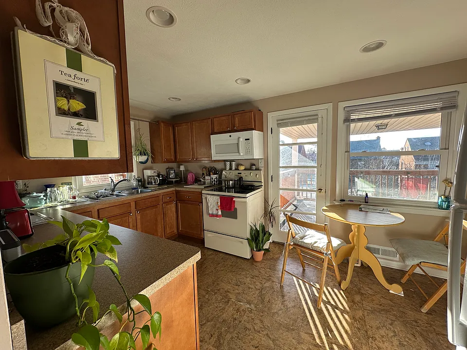 Self cleaning glass top range and over counter microwave. Covered porch accessible from the kitchen.
