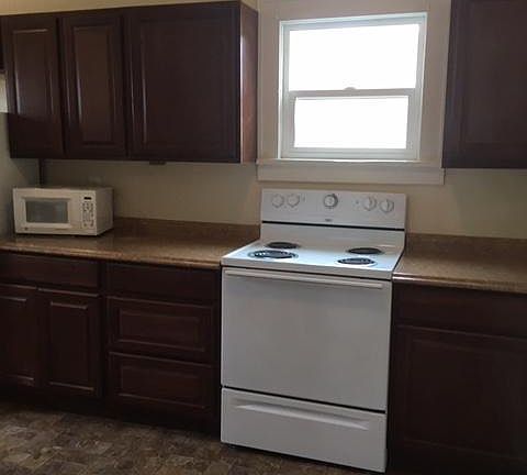 Kitchen is fully furnished with dishes and cooking accessories