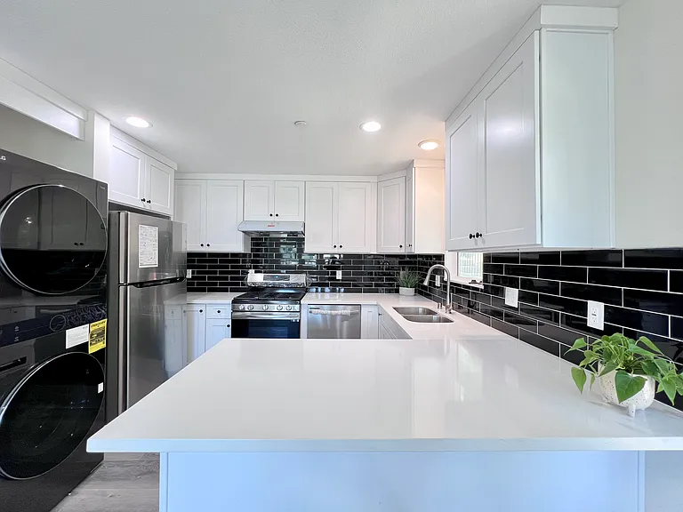 beautiful quartz countertop with black tile backsplash