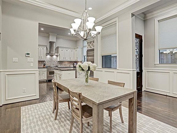 Additional view of dining room and lovely windows allowing an abundance of natural light. All shutters and shades.