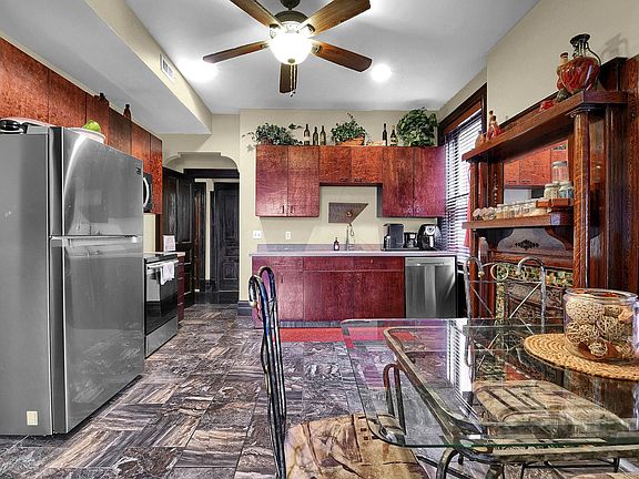 Looking into Kitchen from Living Room - stainless appliances, marbled tile floors, ample cabinetry