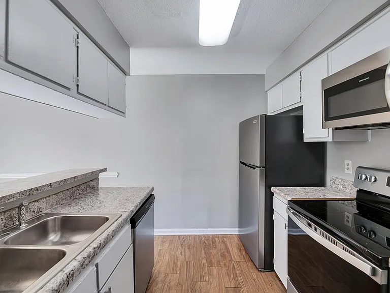 A large kitchen featuring new stainless steel appliances