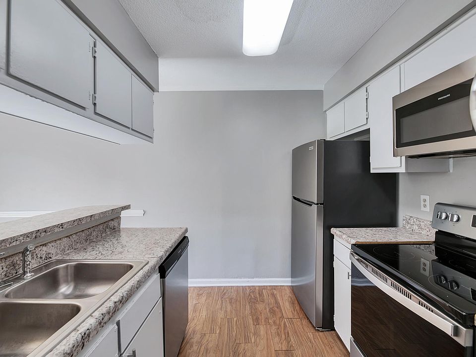 A large kitchen featuring new stainless steel appliances