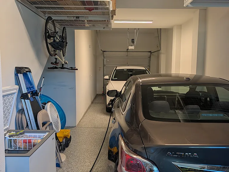 Garage space for 2 cars, EV charger, and deep freezer