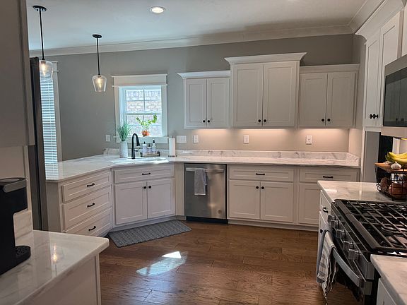 Kitchen featuring marble countertops and a gas stove