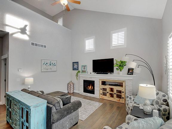 Great Room with Six Sunny Windows, Custom Entertainment Center For Your Electronics, Ceiling Fan, Gas Fireplace, and Engineered Hardwood Flooring