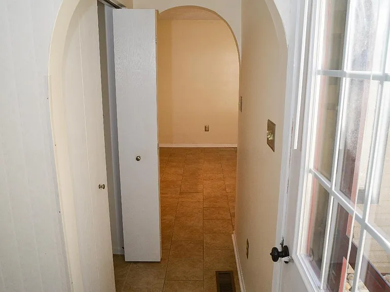 Hallway to Kitchen with coat closet