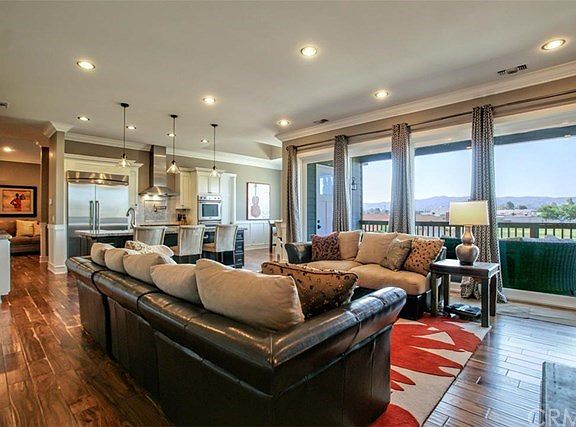 Beautiful Open Living Room with Sliding Door Access to Wrap Around Patio Deck.