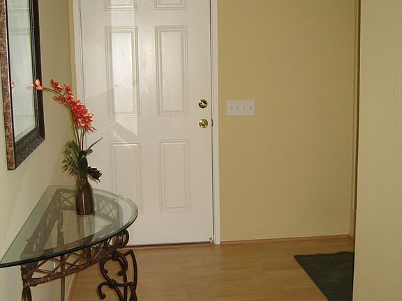 The flooring has been replaced in the entry and kitchen area