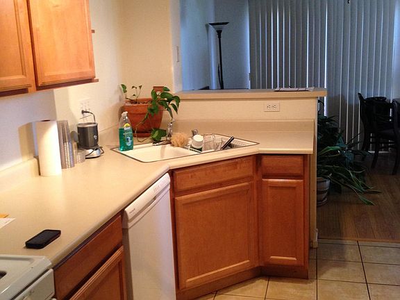 Kitchen with dishwasher, garbage disposal, and view of dining room