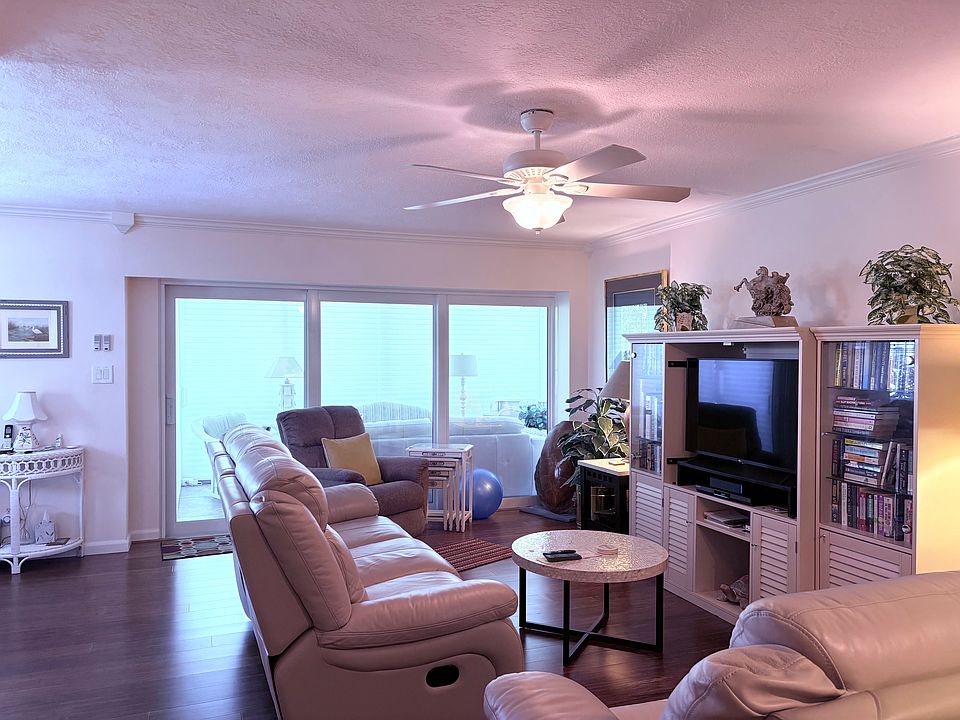 Living area open to enclosed porch overlooking the pool area.