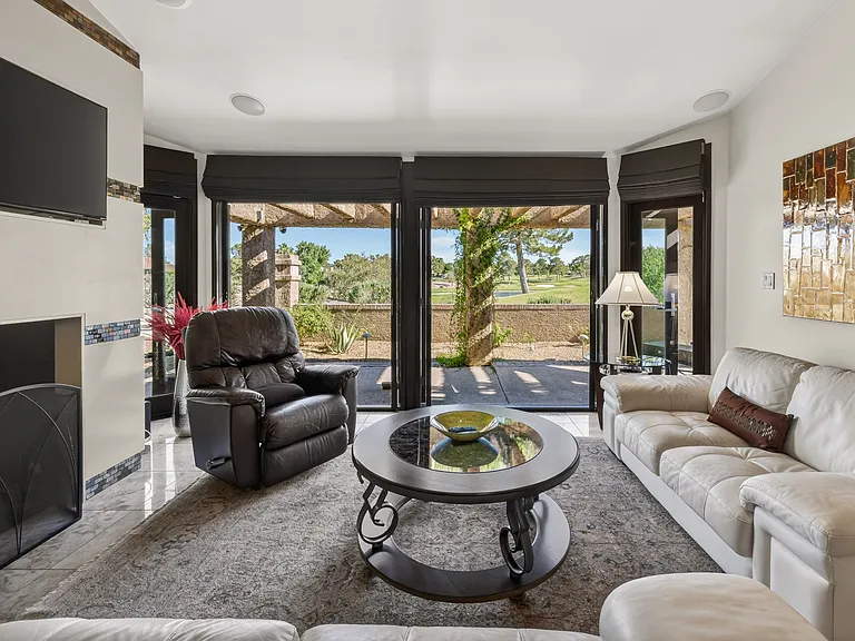 Italian high-end leather couches and silk area rug warm the living room.