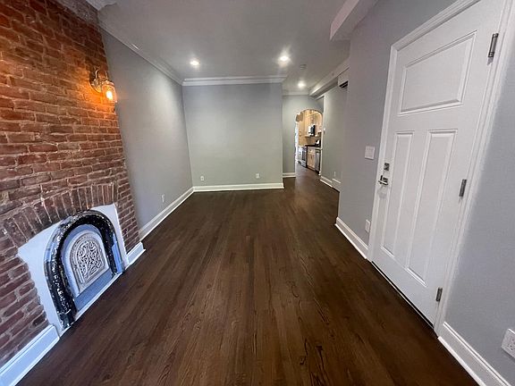 Original circa-1850 brick walls and Edison lights lend character to the living room