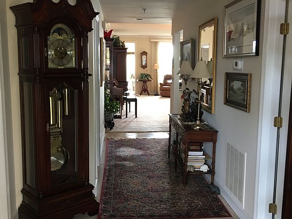 From the front door, looking down hall towards sunroom outsi