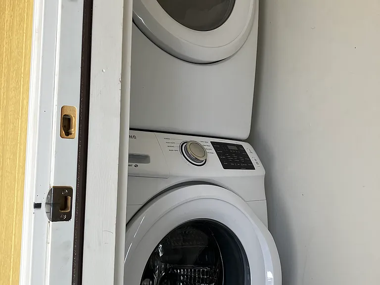 Private laundry room with washer and dryer