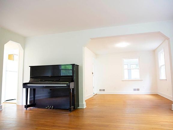 livingroom with piano looking into dinning room 