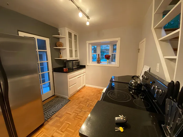 Kitchen view. Door on left to sunroom and backyard. Door on right to basement/laundry (unfinished)