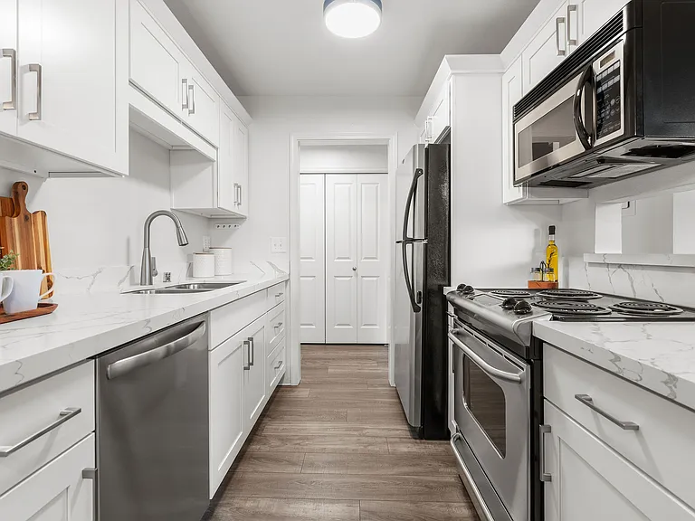Kitchen with newer stainless steel appliances and quartz countertops