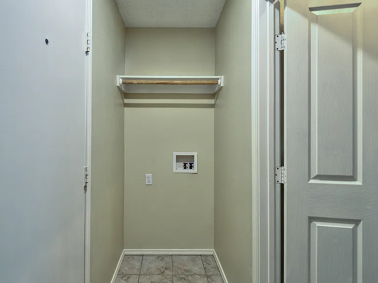 Washer hookup. Dryer hookup on opposite wall. Laundry room is just inside from the garage (on left)