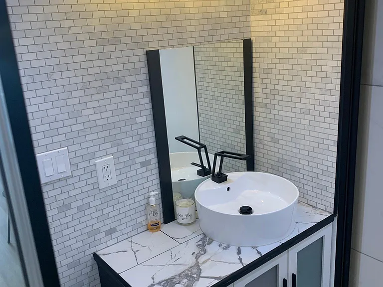 main bathroom vanity with warm Edison lights.