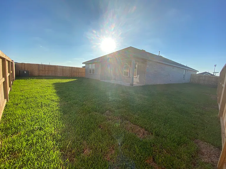 Completely fenced in backyard with plenty of space for pets, children, or gatherings outside