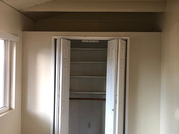 large closet with alcove above go storage