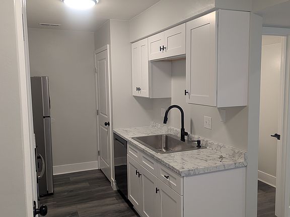 Kitchen sink, with entry to the main level half bath (visible on the right).