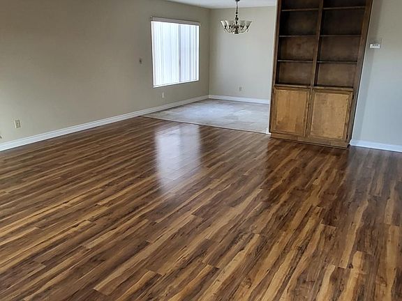 Wide expanse of entry way to living room to dining room.