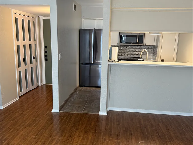 View of Kitchen/Entry and Dining space. Stools can be used at counter.