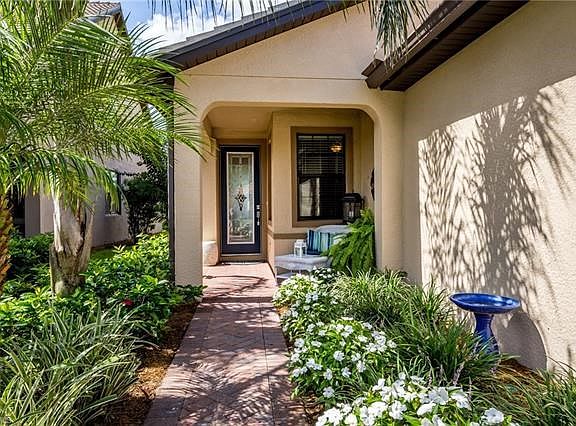 Lovely entrance with rich landscaping