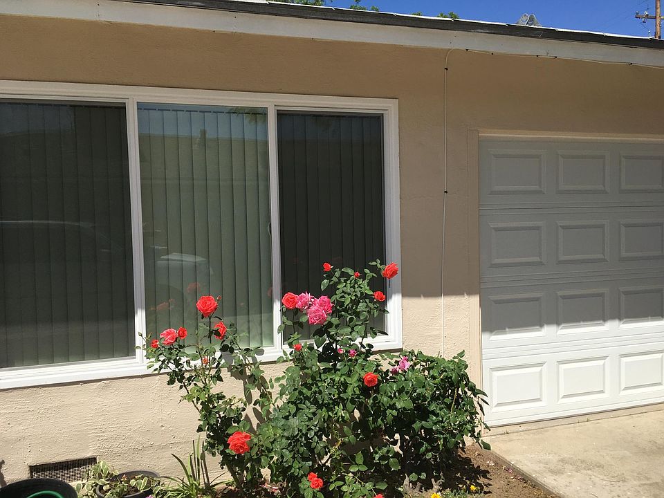 Front of view of duplex with enclosed garage 