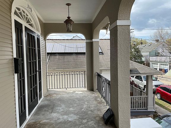 Space for sitting or grilling on front porch.