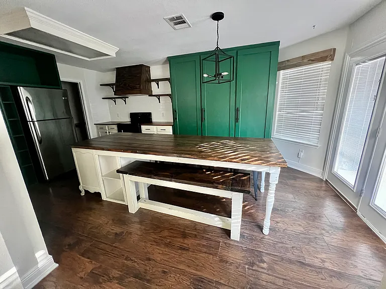Kitchen with bench and chairs around island