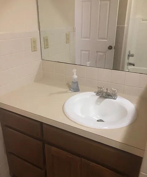 Bathroom sink pictured, toilet and tub are not