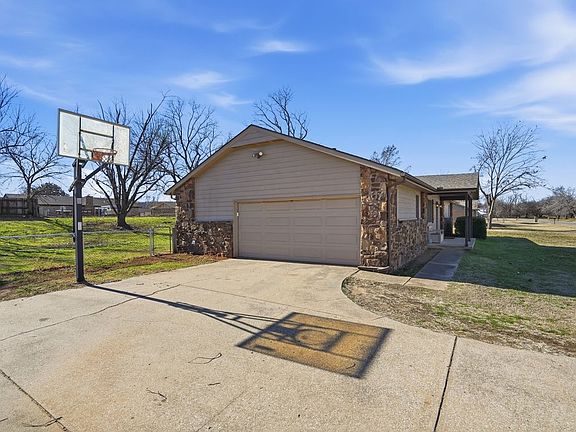Large Driveway with Adjustable Basketball Hoop