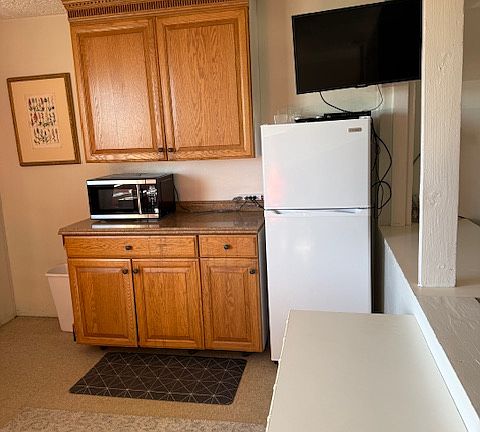 Kitchen work area. Bedroom to the right.
